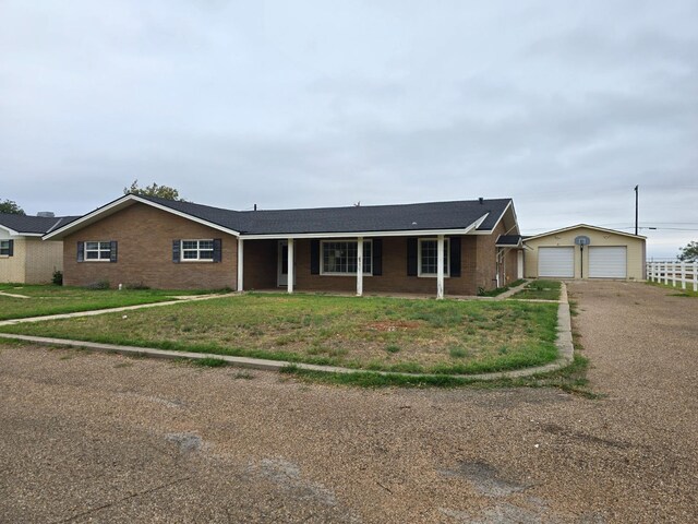 ranch-style house with a porch and a front yard