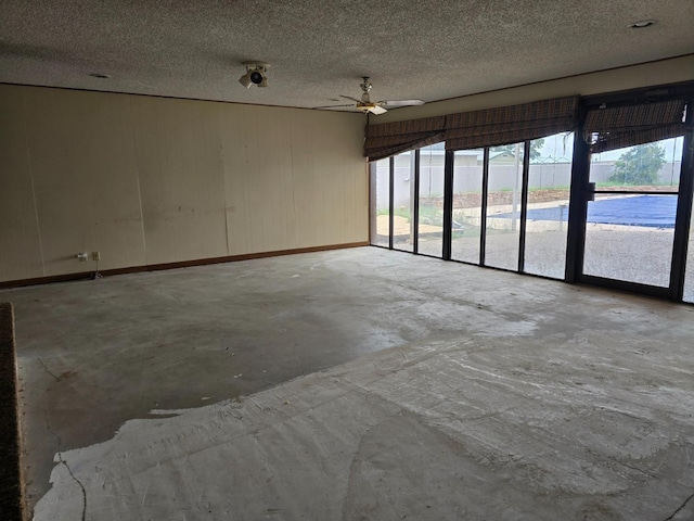 unfurnished room with concrete flooring and a textured ceiling