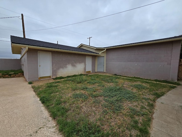 view of property exterior featuring a lawn