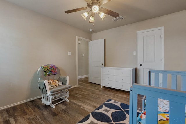 bedroom with dark hardwood / wood-style floors and ceiling fan