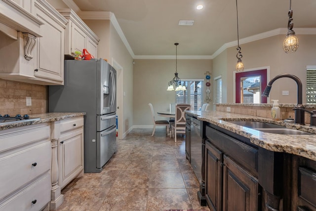 kitchen featuring light stone counters, sink, backsplash, and appliances with stainless steel finishes