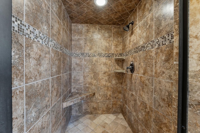 bathroom with tiled shower