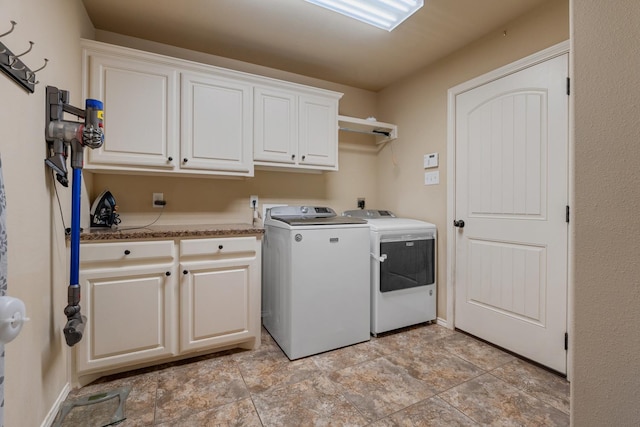 laundry area with cabinets and separate washer and dryer