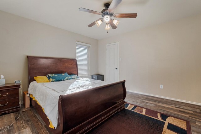 bedroom with ceiling fan and dark hardwood / wood-style flooring