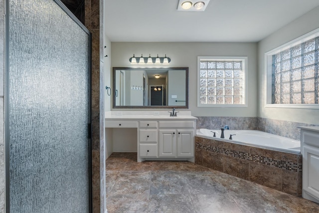 bathroom featuring vanity and separate shower and tub