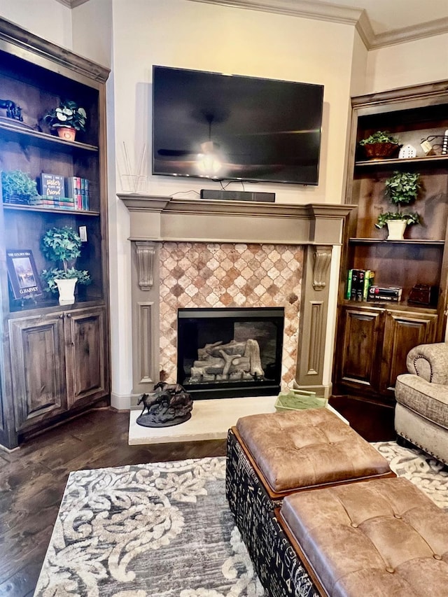 interior space featuring dark hardwood / wood-style floors, ornamental molding, a fireplace, and built in shelves