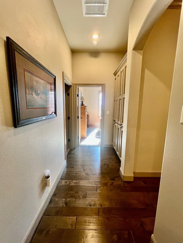 hallway with dark hardwood / wood-style floors