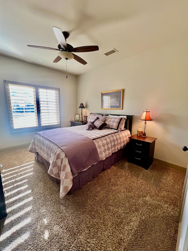 bedroom featuring ceiling fan and carpet