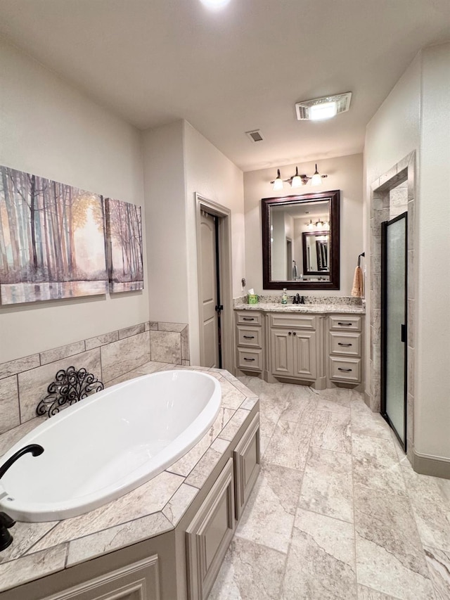 bathroom featuring vanity and shower with separate bathtub