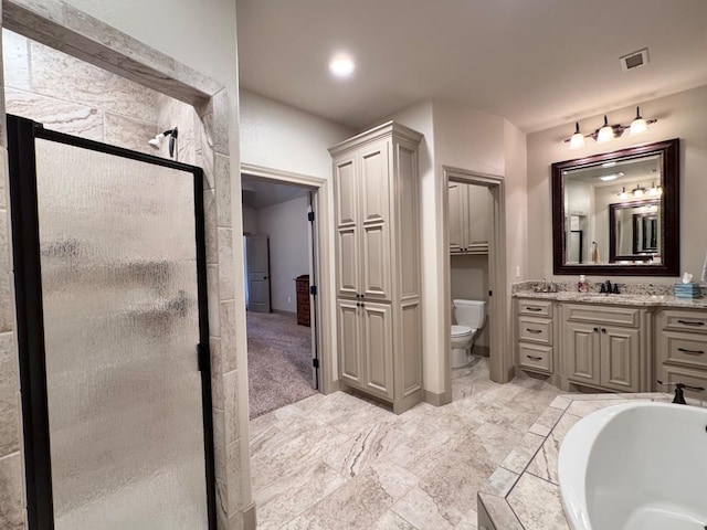 full bathroom featuring vanity, shower with separate bathtub, and toilet