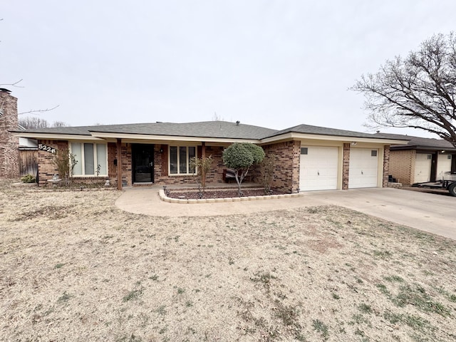 ranch-style house featuring a garage, driveway, and brick siding