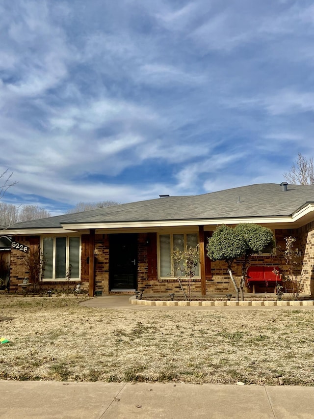 ranch-style house featuring brick siding