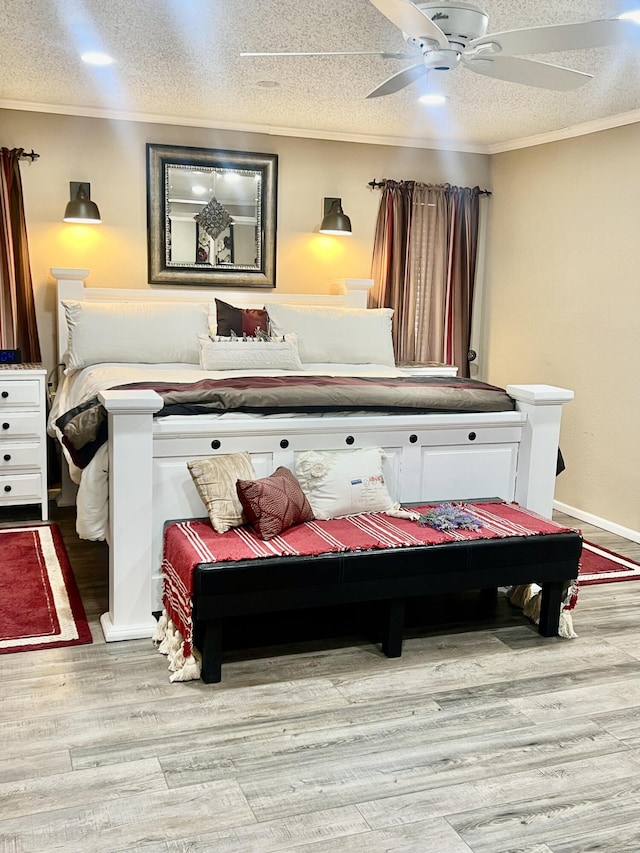 bedroom with a textured ceiling, light wood finished floors, and crown molding