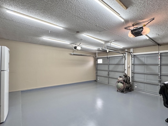 garage with freestanding refrigerator and a garage door opener