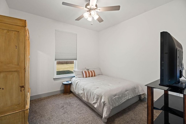 carpeted bedroom with a ceiling fan and baseboards