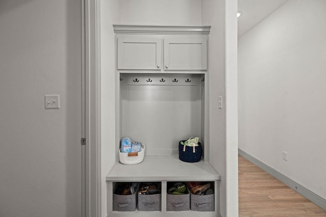 mudroom with light wood-style flooring and baseboards