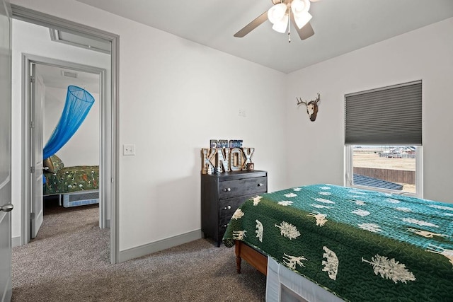 carpeted bedroom with baseboards and a ceiling fan
