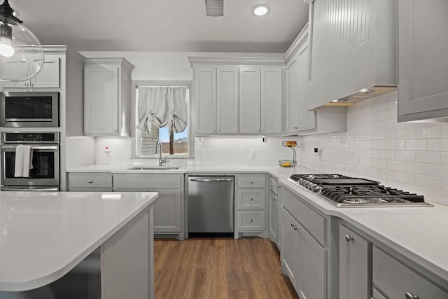 kitchen featuring a sink, visible vents, appliances with stainless steel finishes, and light countertops