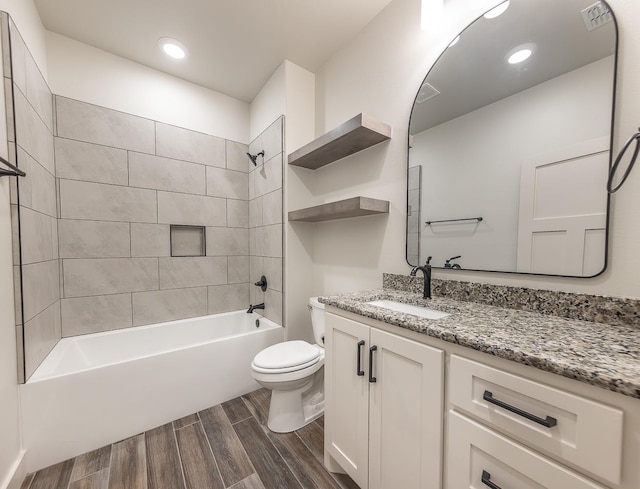 full bathroom with wood finish floors, visible vents, toilet,  shower combination, and vanity