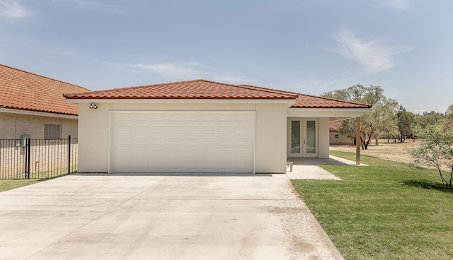 mediterranean / spanish home with french doors, a tile roof, driveway, and a front yard