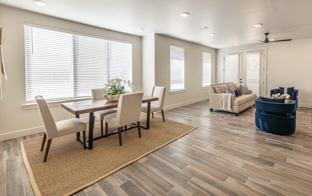 dining room featuring visible vents, baseboards, ceiling fan, and wood finished floors