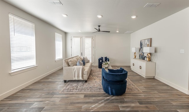 living area featuring visible vents, wood finished floors, and a ceiling fan