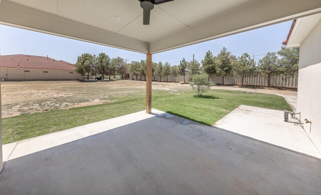 view of patio with ceiling fan and fence