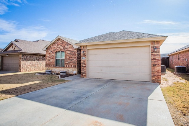 ranch-style home with cooling unit and a garage