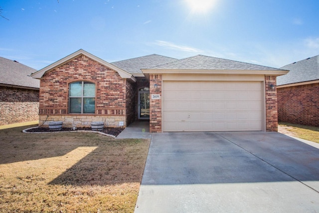 ranch-style home with a garage and a front lawn