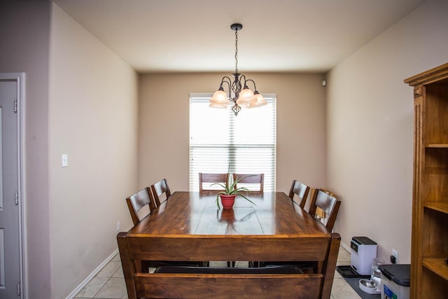 dining area featuring light tile patterned floors and an inviting chandelier