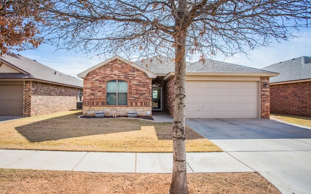 single story home with cooling unit and a garage