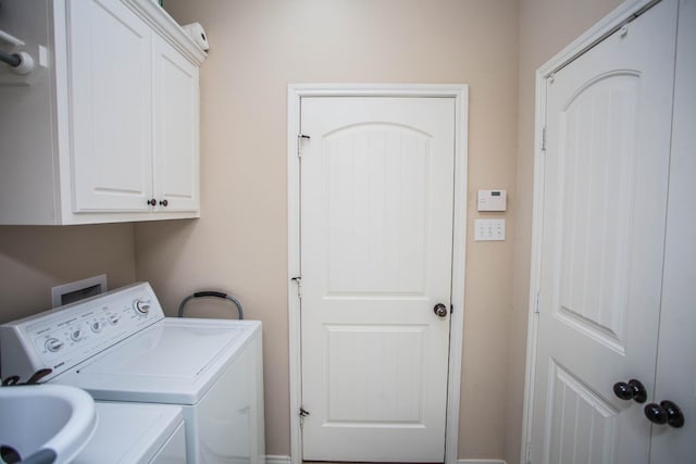 laundry area featuring cabinets and washer and clothes dryer