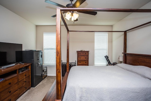 bedroom featuring ceiling fan and dark colored carpet