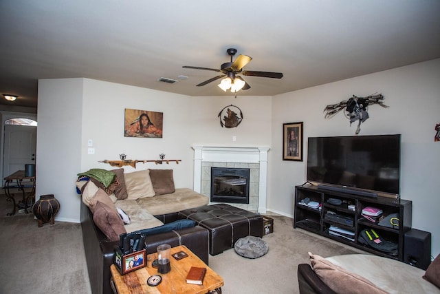 carpeted living room featuring a fireplace and ceiling fan