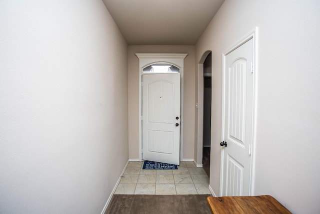 doorway with light tile patterned floors