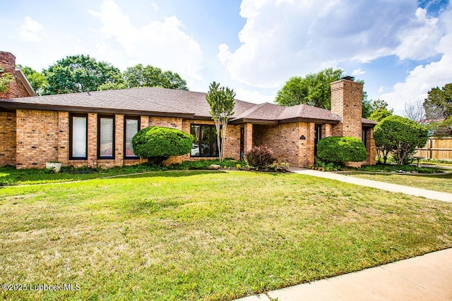 9206 Wayne Ave, Lubbock, TX 79424 - ranch-style house featuring a chimney, brick siding, and roof with shingles
