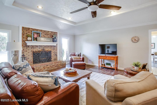 9206 Wayne Ave, Lubbock, TX 79424 - living room with a tray ceiling, baseboards, a ceiling fan, wood finished floors, and crown molding