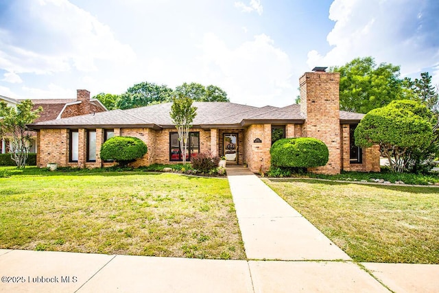 9206 Wayne Ave, Lubbock, TX 79424 - view of front of home with a chimney, a front lawn, brick siding, and a shingled roof