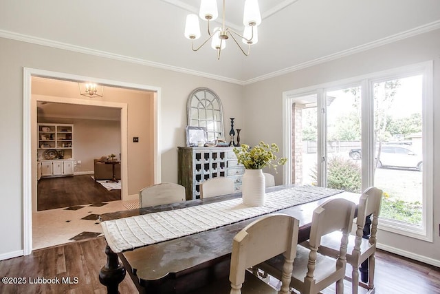 9206 Wayne Ave, Lubbock, TX 79424 - dining room with a chandelier, dark wood-type flooring, and ornamental molding