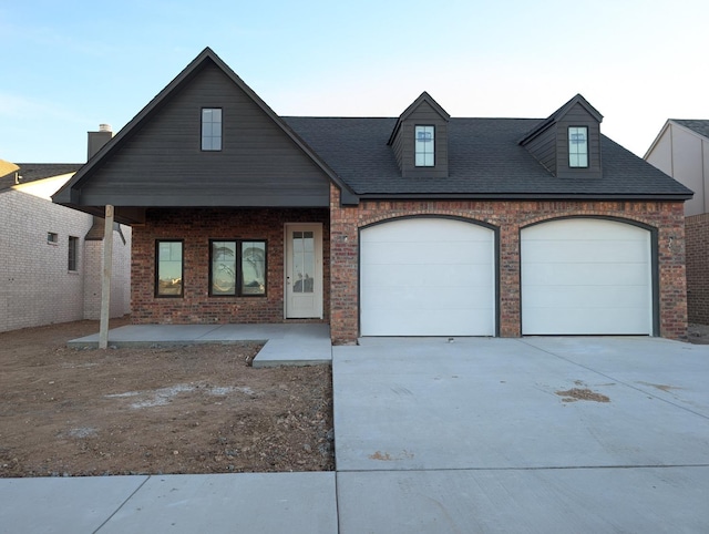 view of front of property with a garage and covered porch