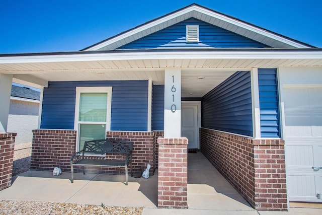 doorway to property featuring covered porch