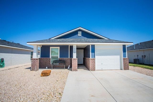 view of front facade featuring cooling unit, a porch, and a garage