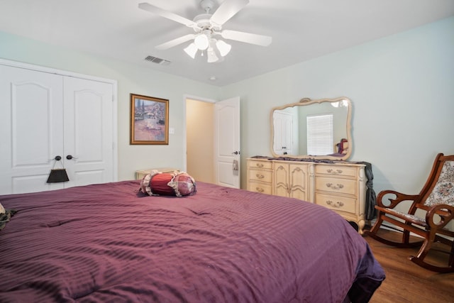 bedroom with ceiling fan, dark hardwood / wood-style flooring, and a closet