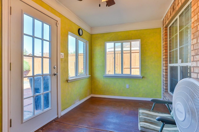 sunroom / solarium featuring a healthy amount of sunlight and ceiling fan