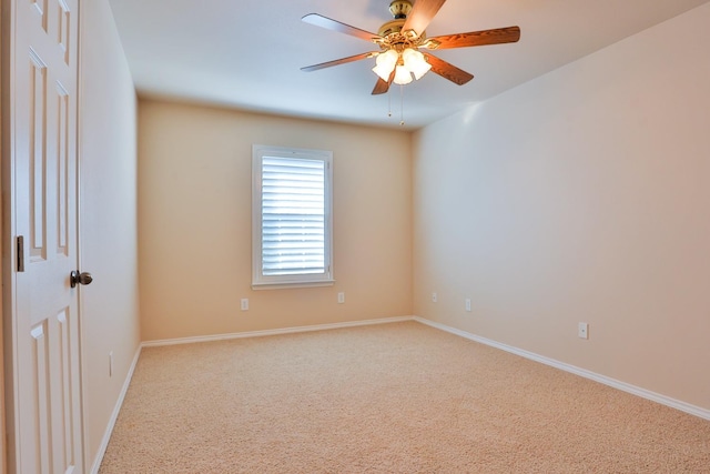 empty room with ceiling fan and carpet