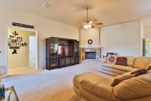 living room featuring light carpet, a fireplace, and ceiling fan