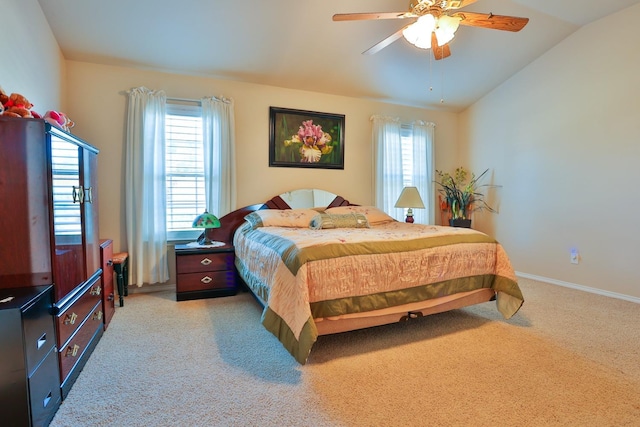 bedroom with multiple windows, lofted ceiling, light colored carpet, and ceiling fan