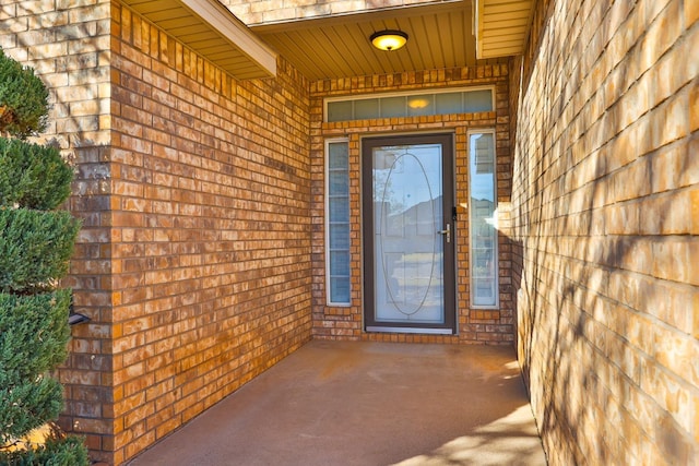 view of exterior entry featuring a patio area