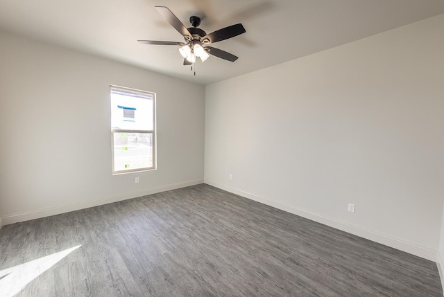 empty room with dark hardwood / wood-style flooring and ceiling fan