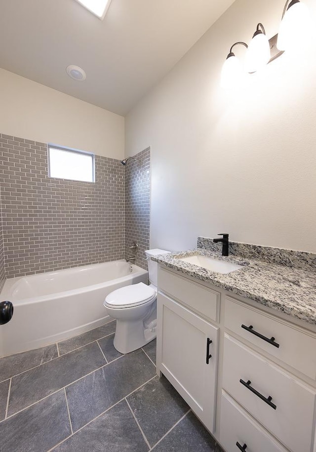 full bathroom with vanity, toilet, and tiled shower / bath combo